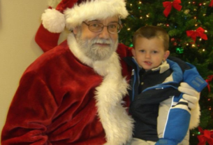 Young local child takes picture with Santa