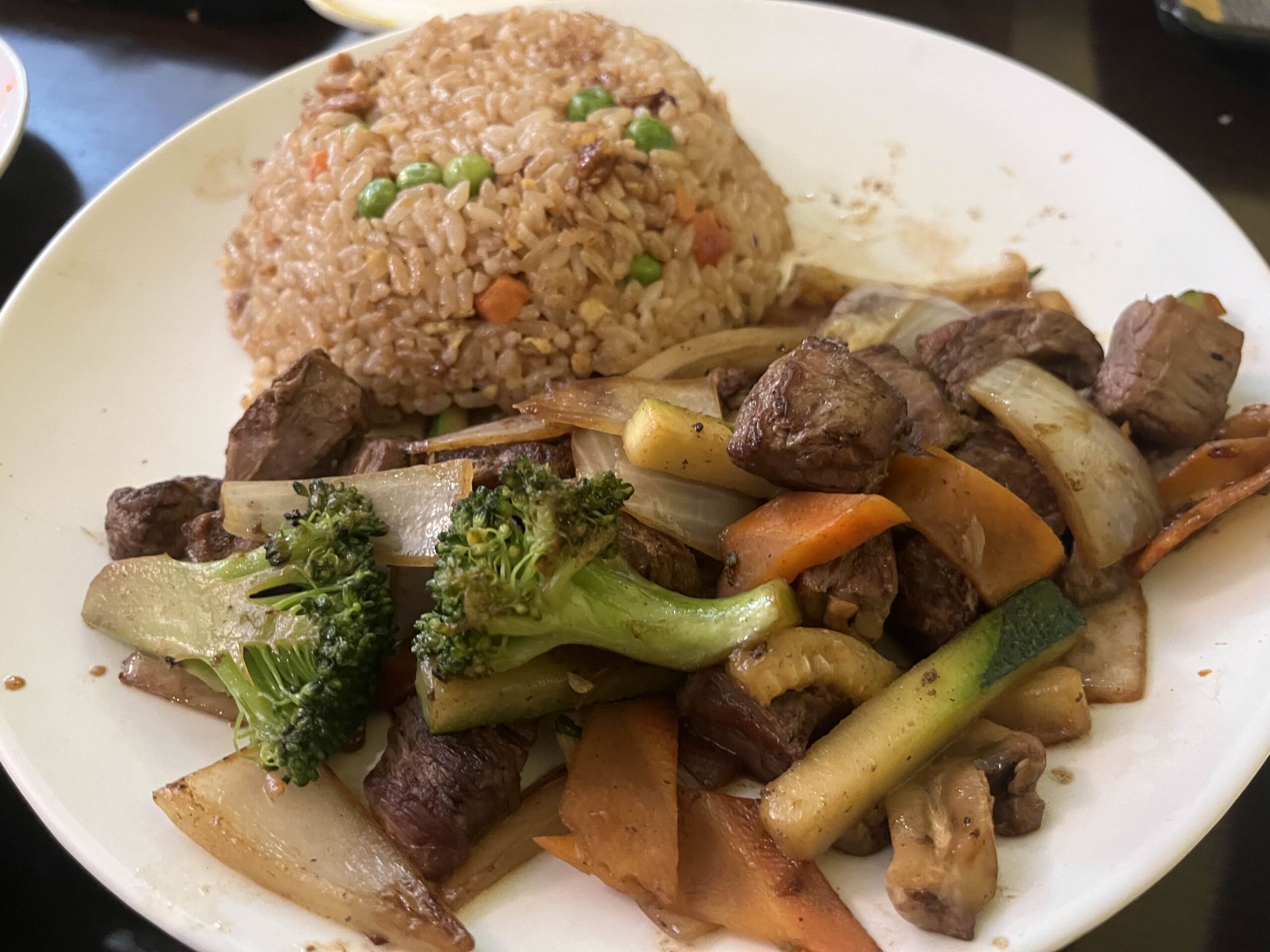 Hibachi Beef and Chicken Fried Rice sit decoratively on a white plate.