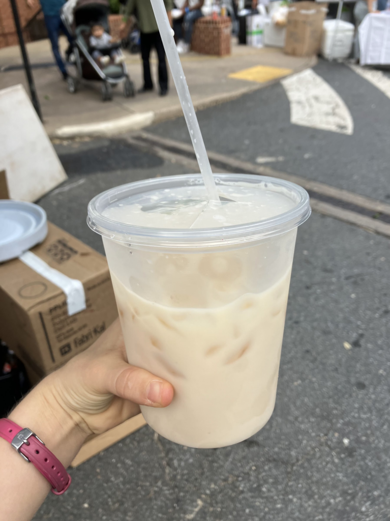 First person view holding a plastic cup of iced Horchata.