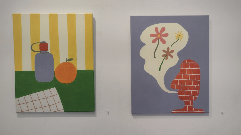 Two simplistic art pieces representing still life and a man made of brick hang on a wall.