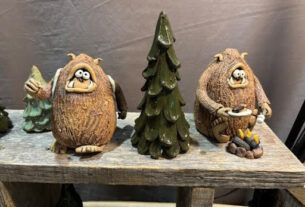 Two brown clay monsters on either side of a green clay pine tree