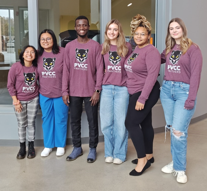 5 female students and 1 male student wearing PVCC Panther shirts pose in the Bolick Center.